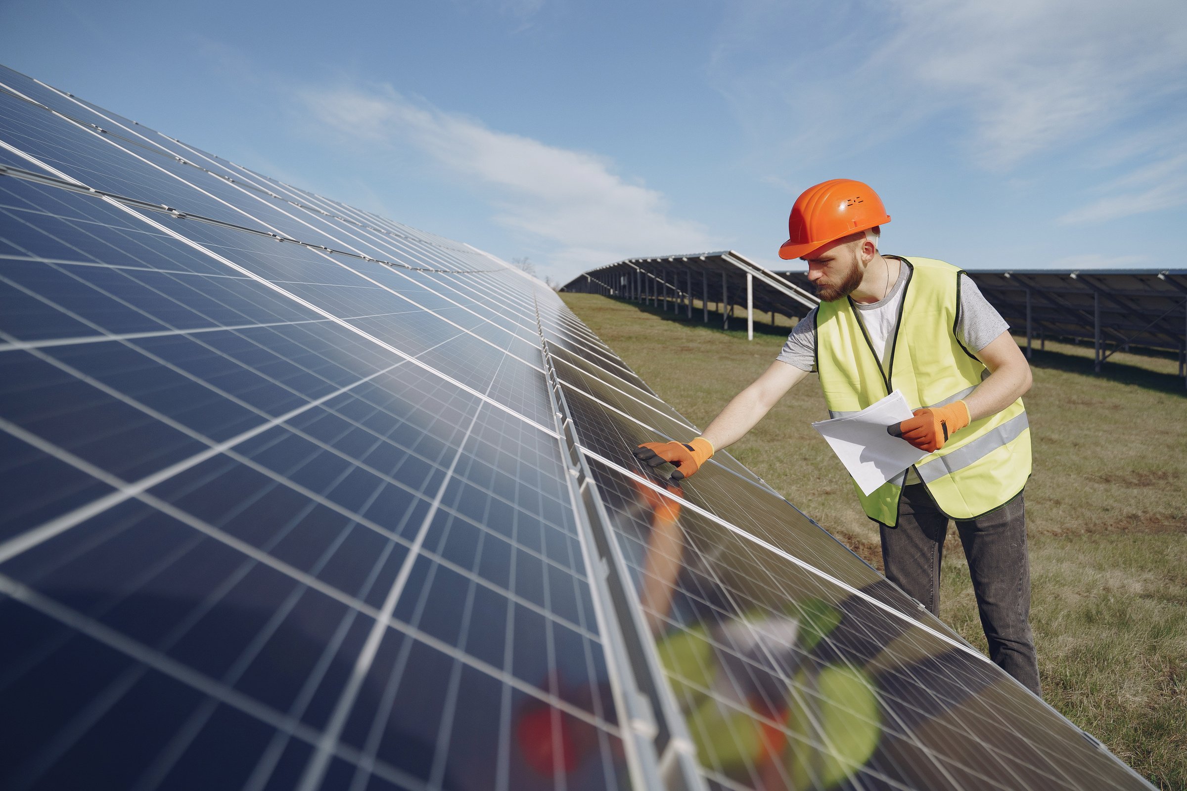 Solar Technician Inspecting Solar Panel